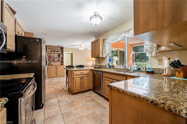 4559 Springview Cir, La Belle, FL 33935 - kitchen featuring appliances with stainless steel finishes, a peninsula, a sink, light tile patterned flooring, and stone countertops
