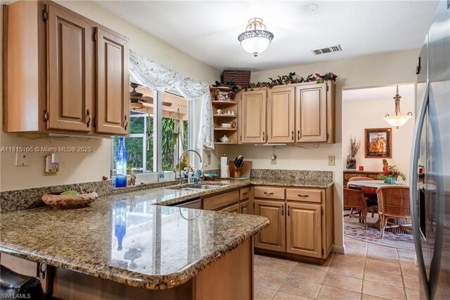 4559 Springview Cir, La Belle, FL 33935 - kitchen with a sink, a peninsula, freestanding refrigerator, stone countertops, and open shelves