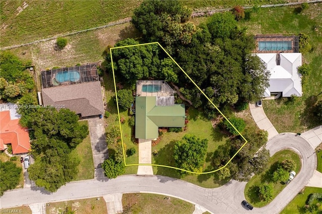 4559 Springview Cir, La Belle, FL 33935 - aerial view of property and surrounding area featuring property parcel outlined and a pool