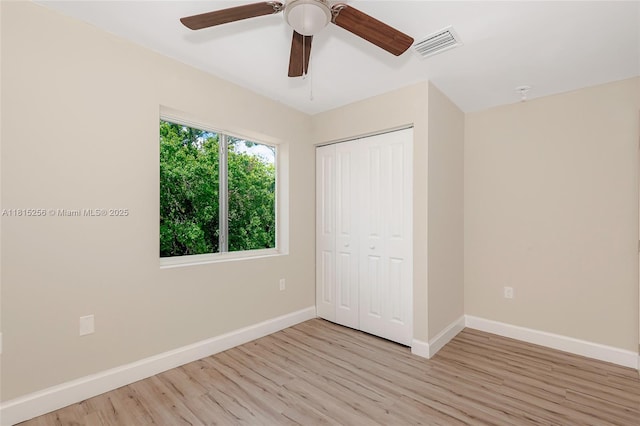 811 NW 3rd Ave, Fort Lauderdale, FL 33311 - unfurnished bedroom with light wood-style flooring, a closet, and a ceiling fan