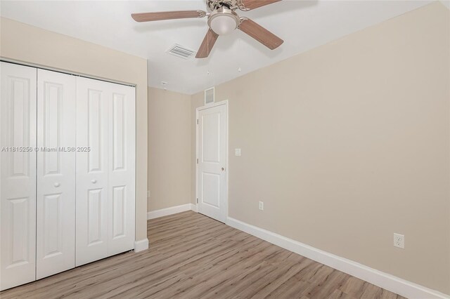 811 NW 3rd Ave, Fort Lauderdale, FL 33311 - unfurnished bedroom with light wood-style floors, a closet, and a ceiling fan