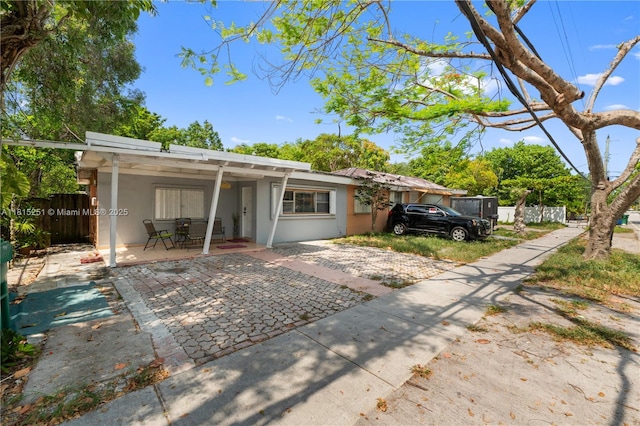 1051 NE 149th St, Miami, FL 33161 - view of front of property featuring stucco siding and a patio area