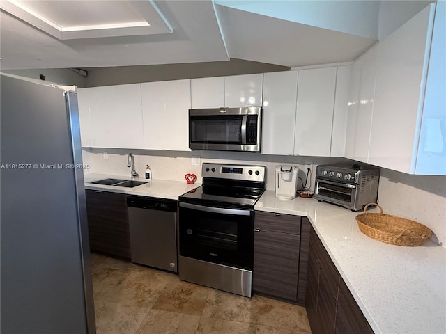 5701 Biscayne Blvd Unit 701, Miami, FL 33137 - kitchen with stainless steel appliances, light countertops, white cabinets, and backsplash