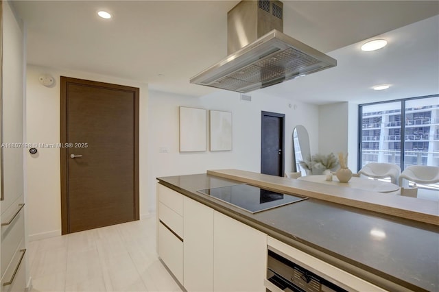 1000 Brickell Plz Unit 2705, Miami, FL 33131 - kitchen featuring wall chimney range hood, black electric cooktop, white cabinets, recessed lighting, and modern cabinets