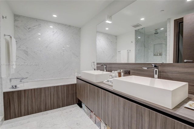 1000 Brickell Plz Unit 2705, Miami, FL 33131 - full bathroom with a bath, double vanity, a marble finish shower, and recessed lighting