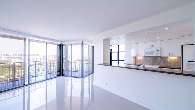 4000 Towerside Ter Unit 2201, Miami, FL 33138 - unfurnished living room with a wall of windows, tile patterned flooring, and baseboards