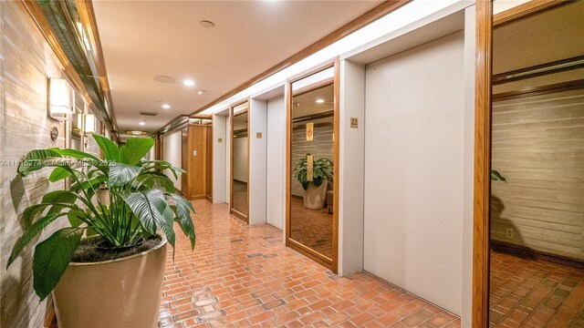 4000 Towerside Ter Unit 2201, Miami, FL 33138 - hallway featuring brick flooring, elevator, and recessed lighting