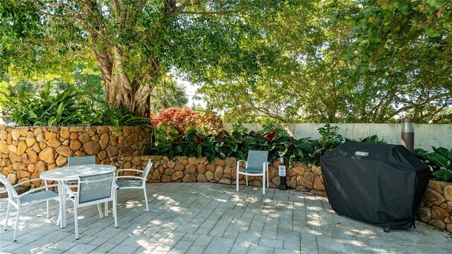4000 Towerside Ter Unit 2201, Miami, FL 33138 - wooden deck with a grill, outdoor dining space, and a patio