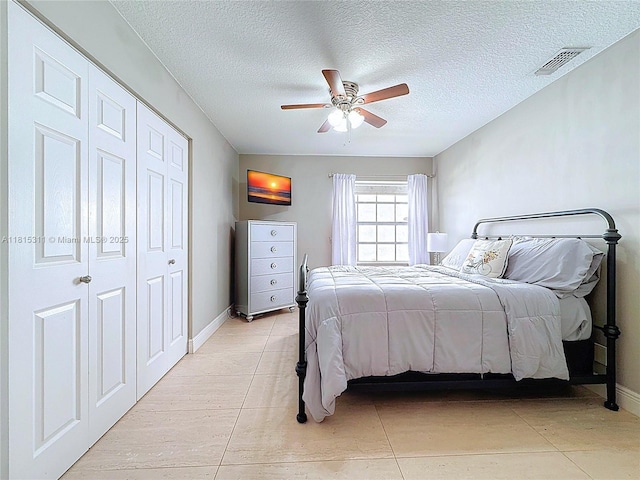 1420 Seagrape Cir, Weston, FL 33326 - bedroom featuring a textured ceiling, light tile patterned floors, ceiling fan, and baseboards
