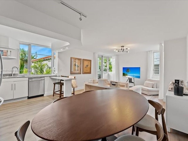 1532 Drexel Ave Unit 204, Miami Beach, FL 33139 - dining area featuring track lighting, light wood-style flooring, and a chandelier