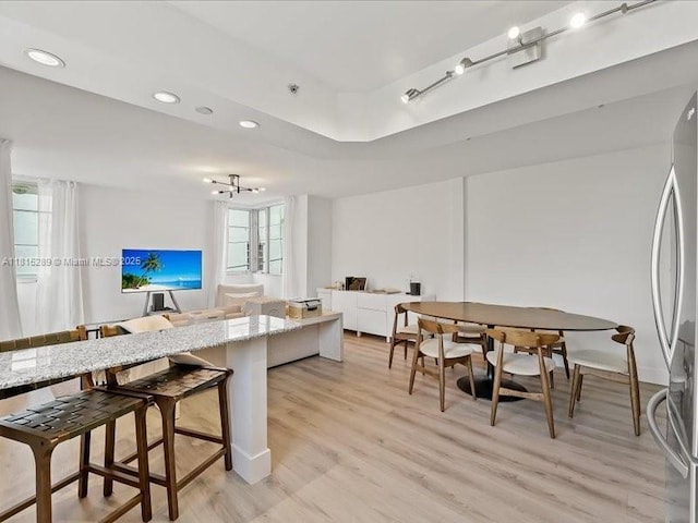 1532 Drexel Ave Unit 204, Miami Beach, FL 33139 - kitchen featuring stainless steel fridge, light wood-type flooring, recessed lighting, open floor plan, and light stone countertops