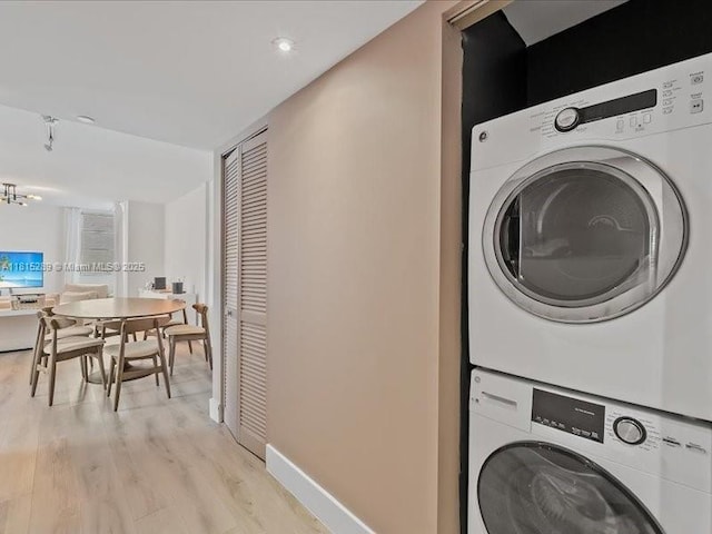 1532 Drexel Ave Unit 204, Miami Beach, FL 33139 - washroom featuring stacked washer / dryer, light wood finished floors, recessed lighting, and baseboards