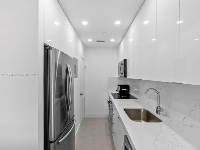 1200 W Ave Unit Ph24, Miami Beach, FL 33139 - kitchen with stainless steel appliances, modern cabinets, a sink, white cabinets, and recessed lighting