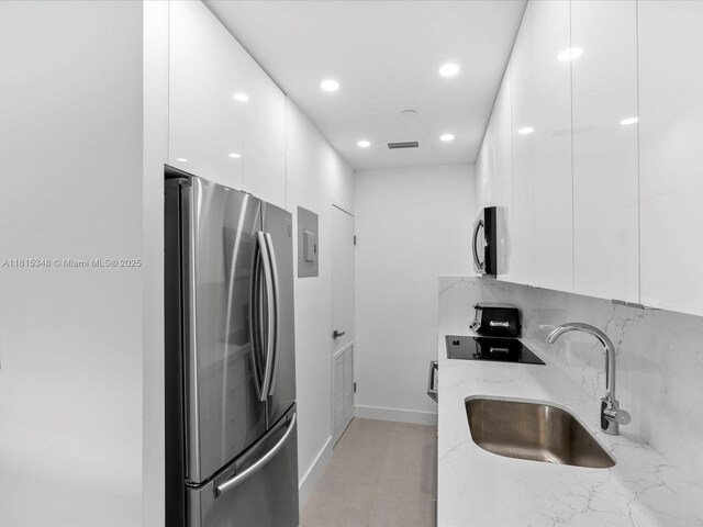 1200 W Ave Unit Ph24, Miami Beach, FL 33139 - kitchen featuring appliances with stainless steel finishes, modern cabinets, a sink, white cabinetry, and recessed lighting