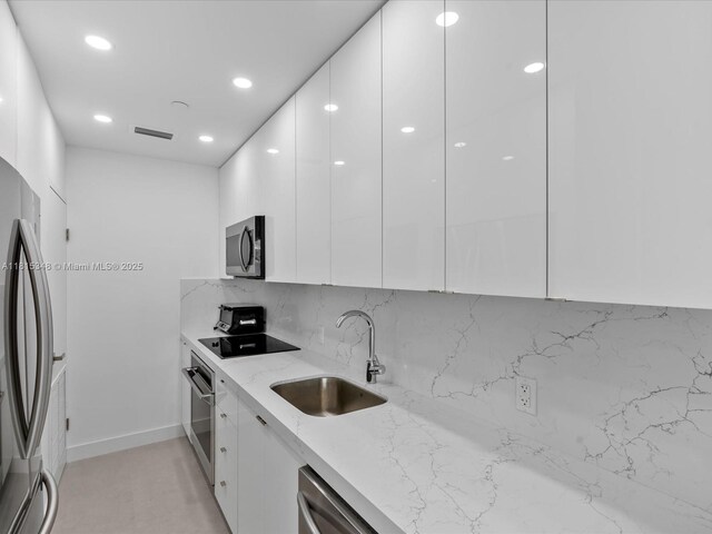 1200 W Ave Unit Ph24, Miami Beach, FL 33139 - kitchen with modern cabinets, a sink, stainless steel appliances, white cabinets, and recessed lighting