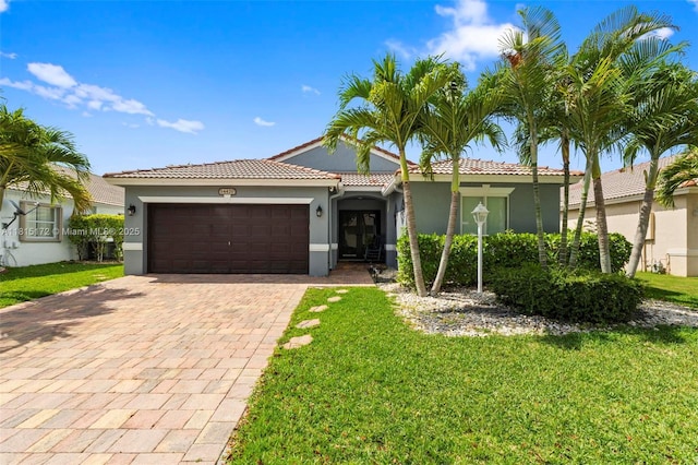 14420 NW 16th St, Pembroke Pines, FL 33028 - mediterranean / spanish-style house with stucco siding, a tiled roof, an attached garage, decorative driveway, and a front yard