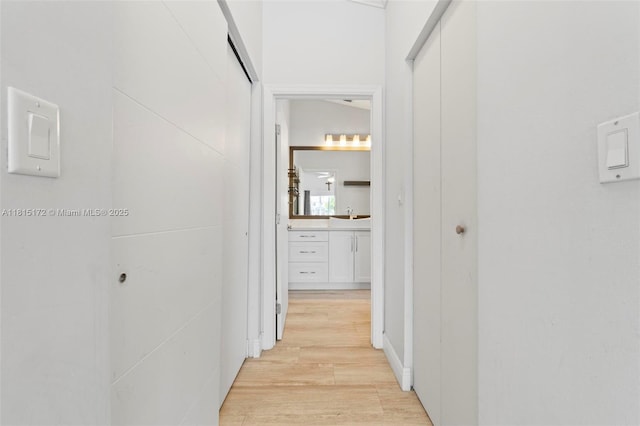 14420 NW 16th St, Pembroke Pines, FL 33028 - hallway featuring light wood-style floors and a sink