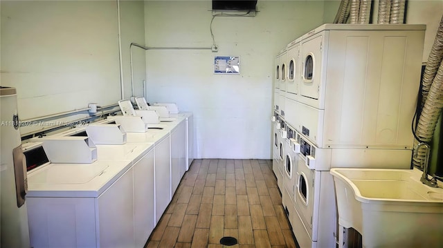16850 S Glades Dr Unit 8G, North Miami Beach, FL 33162 - community laundry featuring stacked washing machine and dryer, washing machine and clothes dryer, and dark wood-type flooring