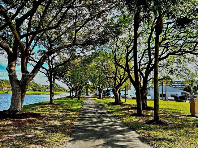 16850 S Glades Dr Unit 8G, North Miami Beach, FL 33162 - view of property's community featuring a water view and a lawn