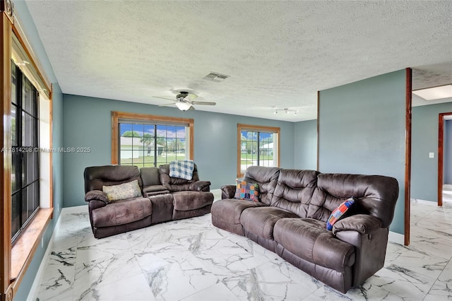 2398 SE Bordeaux Ct, Port St Lucie, FL 34952 - living area featuring marble finish flooring, ceiling fan, and baseboards
