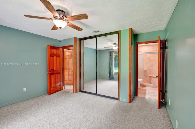 2398 SE Bordeaux Ct, Port St Lucie, FL 34952 - unfurnished bedroom featuring carpet flooring, a closet, a textured ceiling, and baseboards
