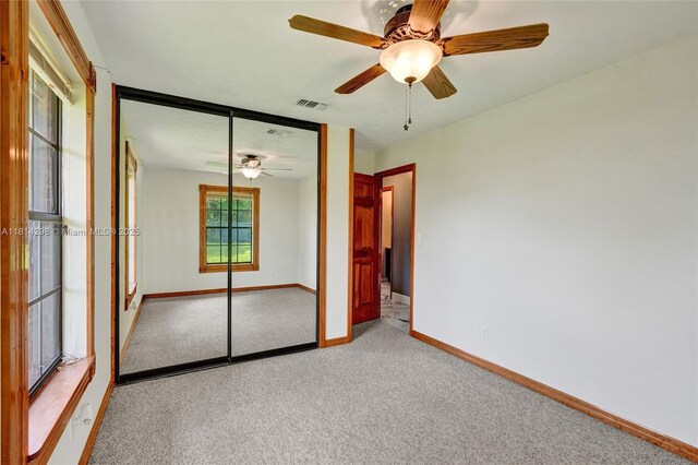 2398 SE Bordeaux Ct, Port St Lucie, FL 34952 - unfurnished bedroom featuring carpet, baseboards, a closet, and a ceiling fan