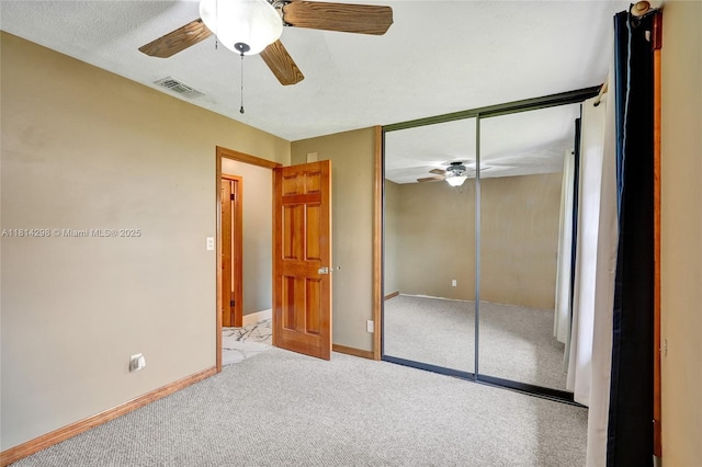 2398 SE Bordeaux Ct, Port St Lucie, FL 34952 - unfurnished bedroom with carpet flooring, a closet, baseboards, and a ceiling fan
