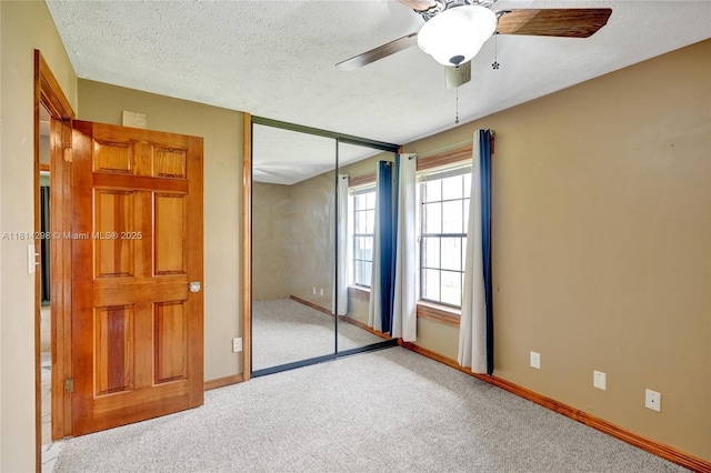 2398 SE Bordeaux Ct, Port St Lucie, FL 34952 - unfurnished bedroom with carpet, a closet, baseboards, a textured ceiling, and ceiling fan