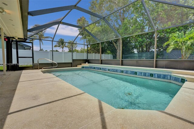 2398 SE Bordeaux Ct, Port St Lucie, FL 34952 - view of swimming pool featuring a patio and glass enclosure