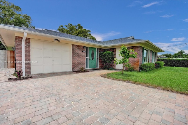 2398 SE Bordeaux Ct, Port St Lucie, FL 34952 - ranch-style house with a garage, brick siding, a front yard, and decorative driveway