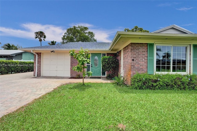2398 SE Bordeaux Ct, Port St Lucie, FL 34952 - ranch-style home with an attached garage, brick siding, decorative driveway, and a front yard