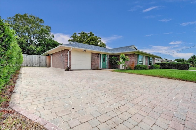 2398 SE Bordeaux Ct, Port St Lucie, FL 34952 - ranch-style home with decorative driveway, an attached garage, brick siding, and a gate