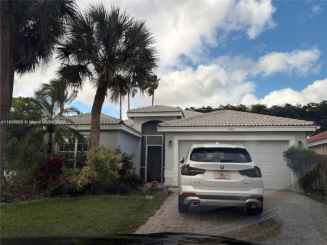 9343 Tango Ter, Boca Raton, FL 33496 - view of front facade featuring decorative driveway, a tile roof, a garage, and stucco siding