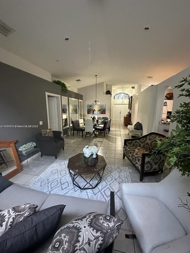 9343 Tango Ter, Boca Raton, FL 33496 - living room featuring tile patterned flooring, arched walkways, and lofted ceiling