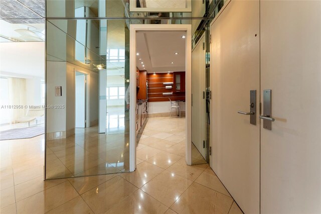 10205 Collins Ave Unit 401, Bal Harbour, FL 33154 - hallway with light tile patterned floors and a towering ceiling