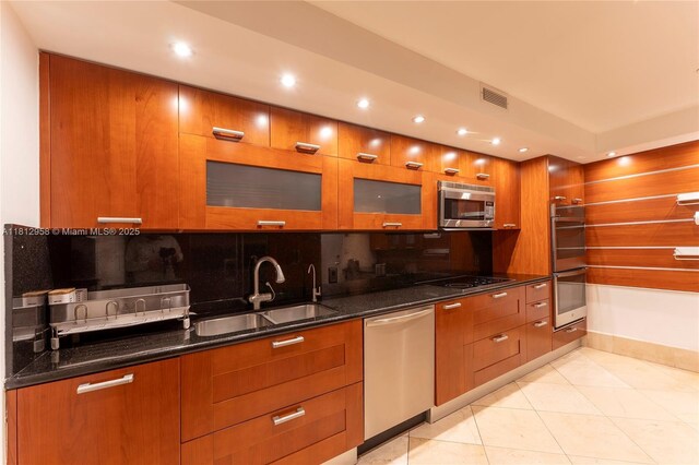 10205 Collins Ave Unit 401, Bal Harbour, FL 33154 - kitchen featuring stainless steel appliances, brown cabinetry, recessed lighting, and modern cabinets
