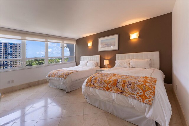 10205 Collins Ave Unit 401, Bal Harbour, FL 33154 - bedroom featuring light tile patterned flooring and baseboards