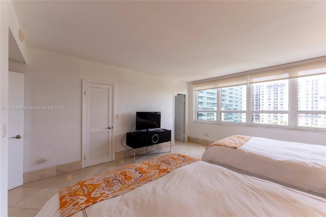 10205 Collins Ave Unit 401, Bal Harbour, FL 33154 - tiled bedroom featuring baseboards