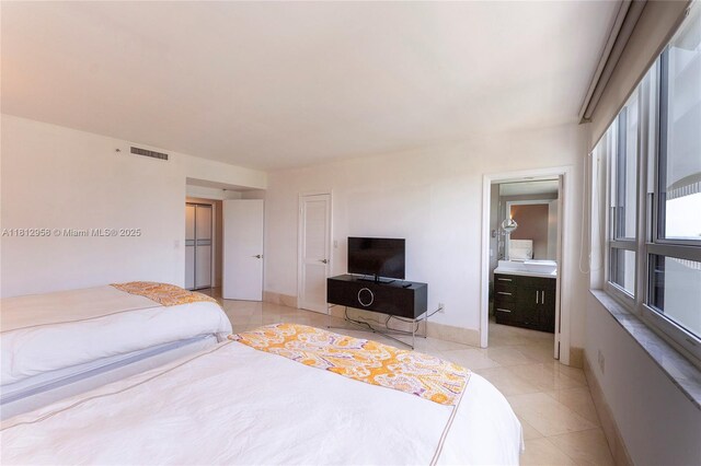 10205 Collins Ave Unit 401, Bal Harbour, FL 33154 - bedroom featuring light tile patterned floors and ensuite bath