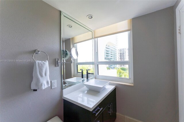 10205 Collins Ave Unit 401, Bal Harbour, FL 33154 - bathroom with vanity and a textured wall