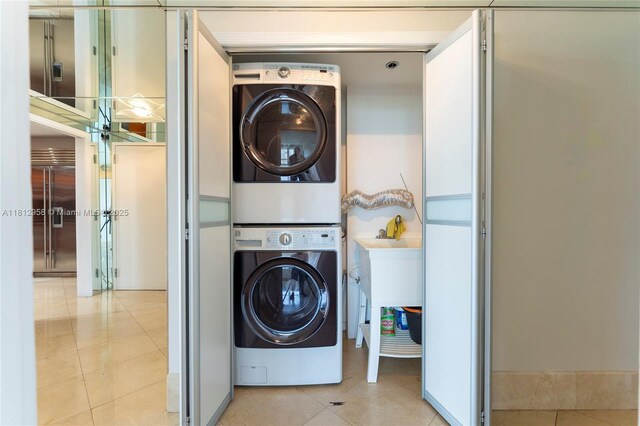10205 Collins Ave Unit 401, Bal Harbour, FL 33154 - laundry room featuring estacked washer and dryer and tile patterned flooring