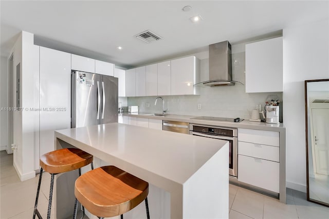 1600 NE 1st Ave Unit 1112, Miami, FL 33132 - kitchen with wall chimney range hood, appliances with stainless steel finishes, a sink, light tile patterned floors, and modern cabinets