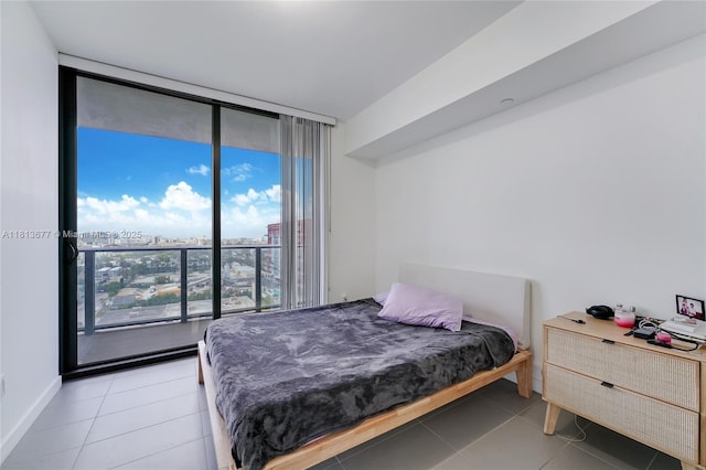 1600 NE 1st Ave Unit 1112, Miami, FL 33132 - bedroom with floor to ceiling windows, light tile patterned floors, a city view, and baseboards