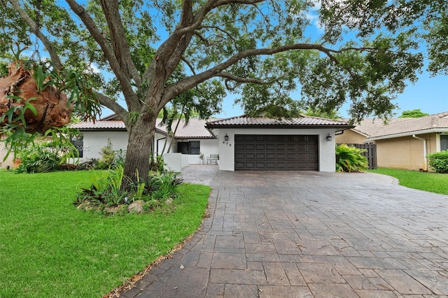 875 NW 108th Ln, Coral Springs, FL 33071 - view of front of property with a tile roof, a garage, a front lawn, decorative driveway, and stucco siding