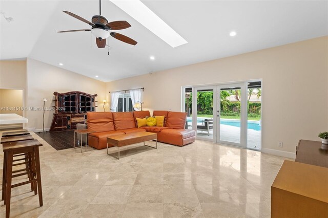 875 NW 108th Ln, Coral Springs, FL 33071 - living room with lofted ceiling, a skylight, ceiling fan, baseboards, and recessed lighting