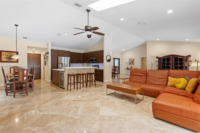 875 NW 108th Ln, Coral Springs, FL 33071 - living room featuring lofted ceiling, a skylight, a ceiling fan, recessed lighting, and wine cooler