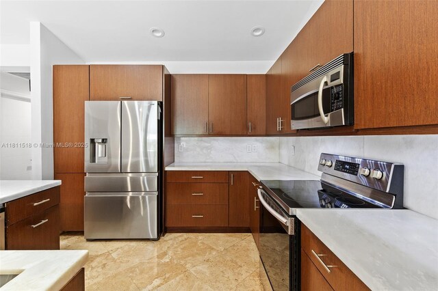 875 NW 108th Ln, Coral Springs, FL 33071 - kitchen featuring stainless steel appliances, light countertops, decorative backsplash, and brown cabinets