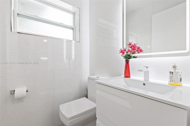 875 NW 108th Ln, Coral Springs, FL 33071 - half bathroom featuring tile walls, toilet, and vanity