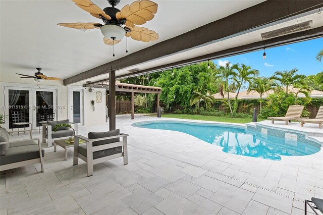 875 NW 108th Ln, Coral Springs, FL 33071 - swimming pool with a patio, a ceiling fan, and french doors