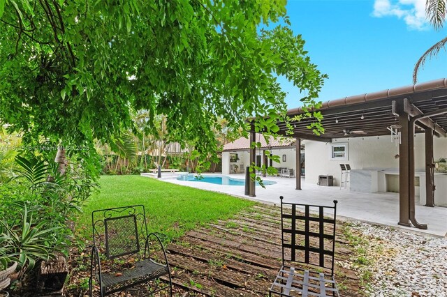 875 NW 108th Ln, Coral Springs, FL 33071 - view of grassy yard with area for grilling, a pergola, and a patio